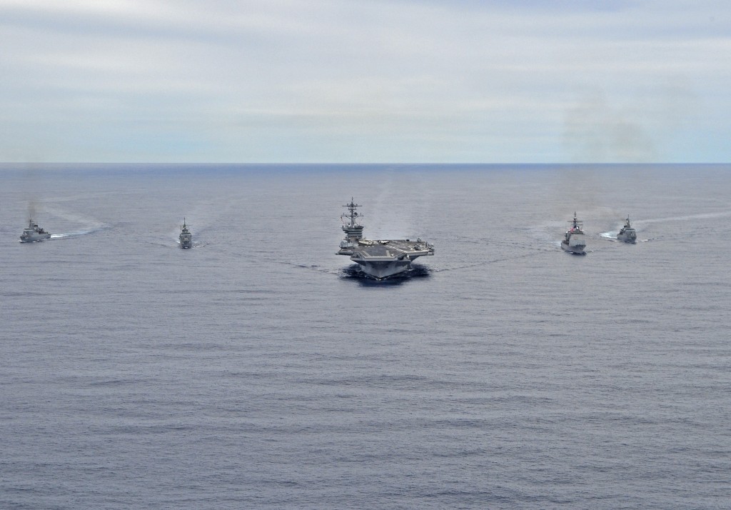 The aircraft carrier USS Carl Vinson (CVN 70), center, and the guided-missile cruiser USS Bunker Hill (CG 52), center right, transit in formation off the coast of Rio de Janeiro with the Brazilian navy ships BNS Independência (F44), BNS Constituição (F44) and BNS Niterói (F40).
