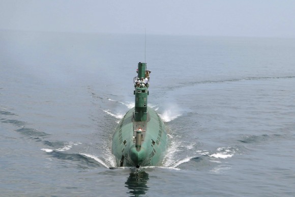 North Korean leader Kim Jong Un (front) stands on the conning tower of a submarine during his inspection of the Korean People's Army (KPA) Naval Unit 167 in this undated photo released by North Korea's Korean Central News Agency (KCNA) in Pyongyang June 16, 2014. REUTERS/KCNA (NORTH KOREA - Tags: POLITICS MILITARY MARITIME)  ATTENTION EDITORS - THIS PICTURE WAS PROVIDED BY A THIRD PARTY. REUTERS IS UNABLE TO INDEPENDENTLY VERIFY THE AUTHENTICITY, CONTENT, LOCATION OR DATE OF THIS IMAGE. FOR EDITORIAL USE ONLY. NOT FOR SALE FOR MARKETING OR ADVERTISING CAMPAIGNS. THIS PICTURE IS DISTRIBUTED EXACTLY AS RECEIVED BY REUTERS, AS A SERVICE TO CLIENTS. NO THIRD PARTY SALES. NOT FOR USE BY REUTERS THIRD PARTY DISTRIBUTORS. SOUTH KOREA OUT. NO COMMERCIAL OR EDITORIAL SALES IN SOUTH KOREA